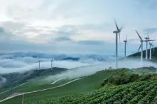 Maebongsan Mt, Taebaek-si, Gangwon-do, Korea - July 30, 2017: Wind power plant turbines are spinning on the cabbage field with sea of cloud